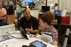 RESNA 2015 Exhibit Hall showing exhibitor interaction with attendee RESNA 2015 Exhibit Hall showing exhibitor interaction with attendee