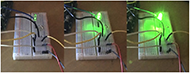  Photo images of the LED when using the prototype control system. Left: a) Low tone, Middle: b) Middle tone, and Right: c) High tone. Here are three pictures. All show the same breadboard and the LED attached to it. The left side represents the low tone, and the LED is lit dimly (dark), the middle side represents the mid-tone, and the LED is lit slightly brighter (meddle), and the right side represents the high tone, and the LED is lit brighter (bright).